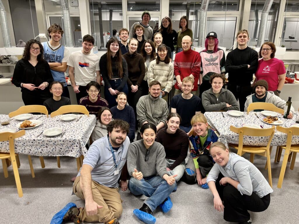 Group photo of university students in a kitchen